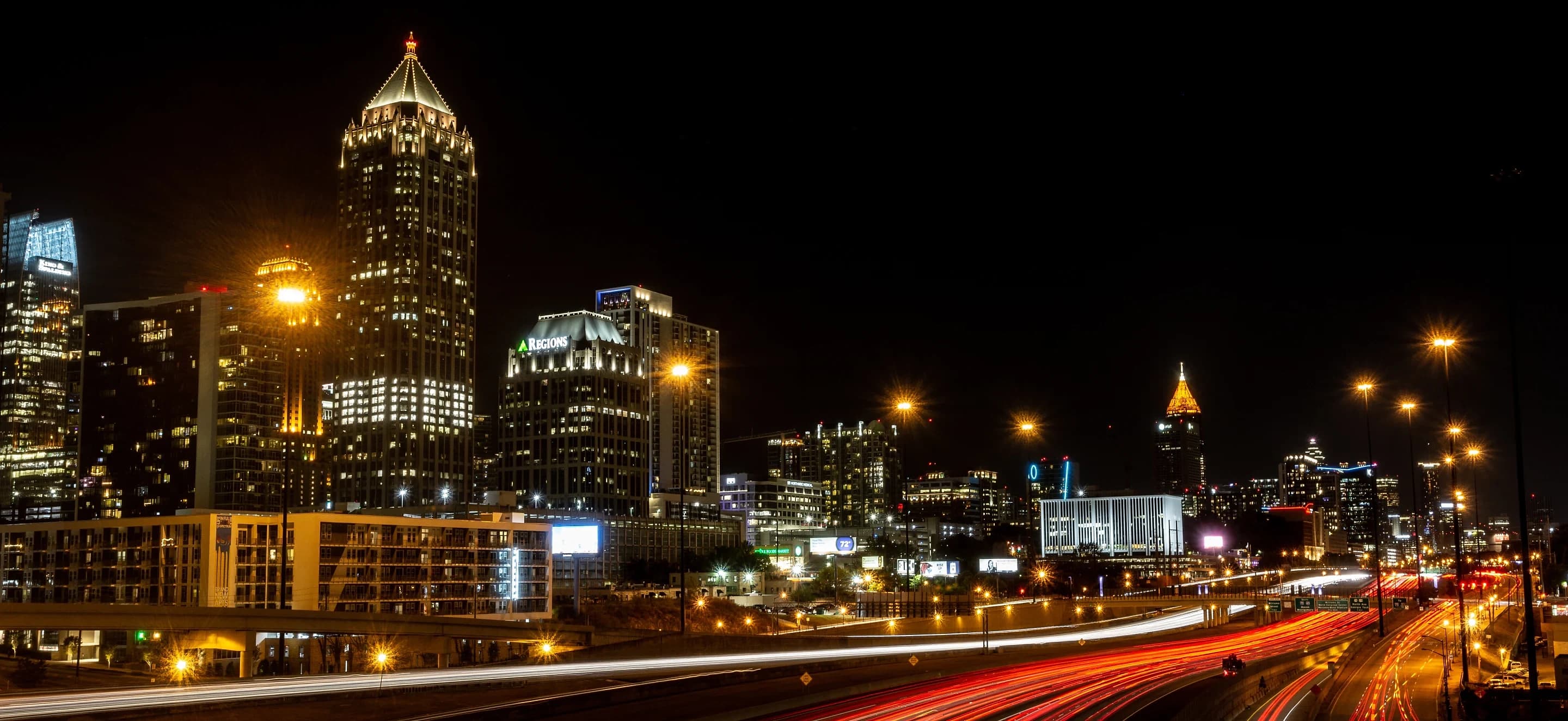 Downtown Atlanta skyline and highway light trails at night